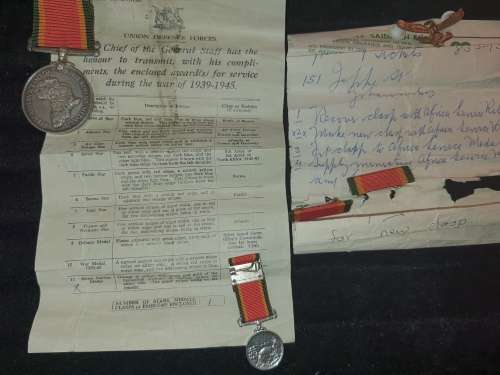 A COLLECTION OF MILITARIA BADGES WITH PAPERWORK SOLD AS IS