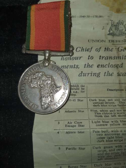 A COLLECTION OF MILITARIA BADGES WITH PAPERWORK SOLD AS IS