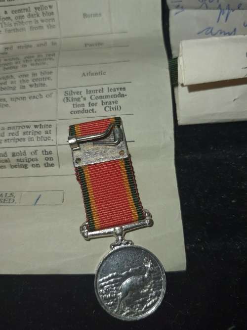 A COLLECTION OF MILITARIA BADGES WITH PAPERWORK SOLD AS IS