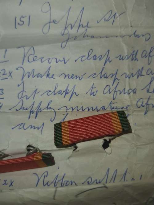 A COLLECTION OF MILITARIA BADGES WITH PAPERWORK SOLD AS IS