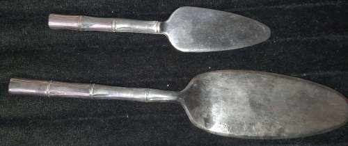 TWO STAINLESS STEEL CAKE LIFTERS SOLD AS IS