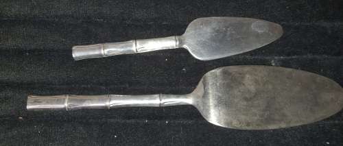 TWO STAINLESS STEEL CAKE LIFTERS SOLD AS IS