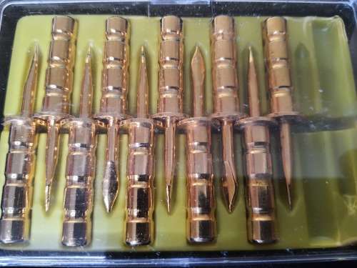 A vintage gold plated corn on the cob holders in its original packaging