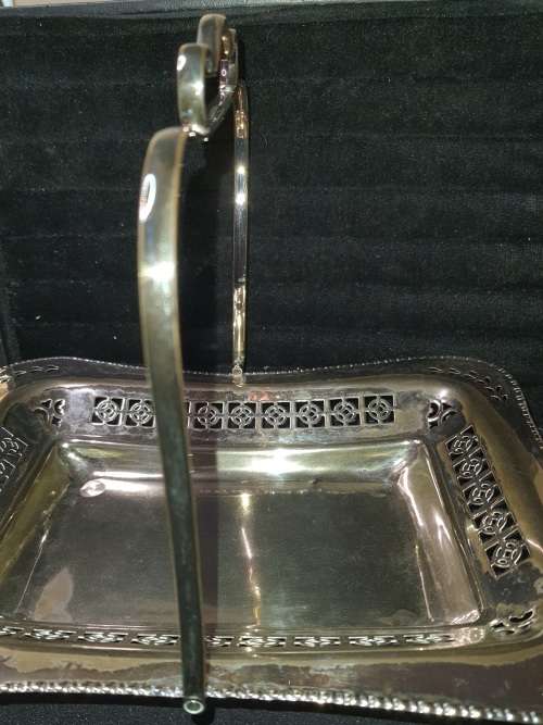 AN ANTIQUE SILVER PLATED BASKET SERVING TRAY IN GOOD CONDITION SOLD AS IS