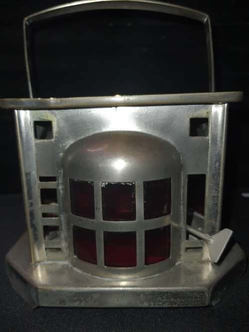 AN ANTIQUE  STAINLESS STEEL LANTETRN WITH A RED GLASS INSERT SOLD AS IS
