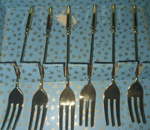 A COMPLETE SET GOLD PLATED COCKTAIL FORKS SOLD AS IS