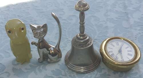 A COLLECTION OF FIGURINES JADE AND SILVER-PLATED BELL AND A BULOVA WATCH SOLD AS IS