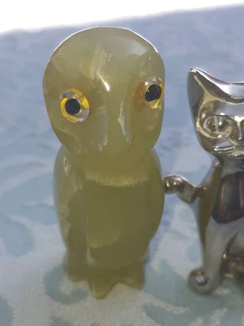 A COLLECTION OF FIGURINES JADE AND SILVER-PLATED BELL AND A BULOVA WATCH SOLD AS IS