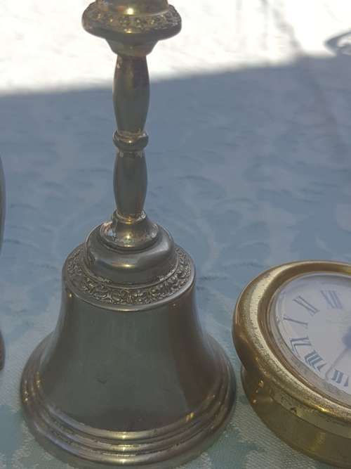 A COLLECTION OF FIGURINES JADE AND SILVER-PLATED BELL AND A BULOVA WATCH SOLD AS IS