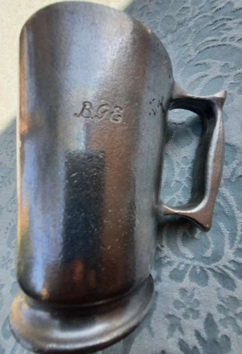 AN ANTIQUE PUTAL BEER MUG MADE IN ENGLAND AND ENGRAVED SOLD AS IS