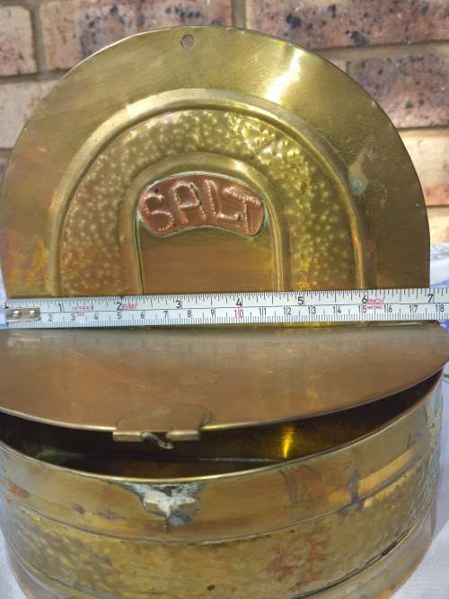 A VINTAGE BRASS DECORATIVE SALTS WALL MOUNT DISPENSOR