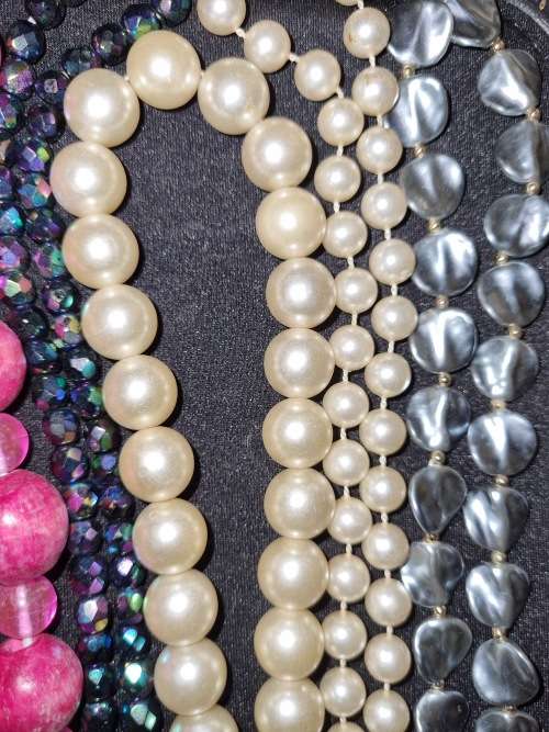 A VINTAGE COLLECTION OF COSTUME BEADED NECKLACES SOLD AS IS