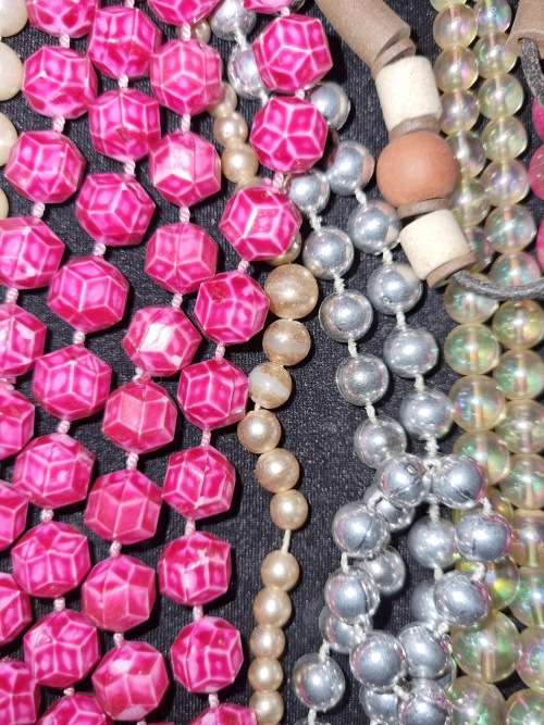 A VINTAGE COLLECTION OF COSTUME BEADED NECKLACES SOLD AS IS