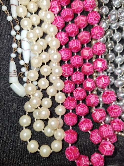A VINTAGE COLLECTION OF COSTUME BEADED NECKLACES SOLD AS IS