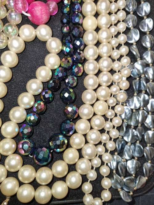 A VINTAGE COLLECTION OF COSTUME BEADED NECKLACES SOLD AS IS