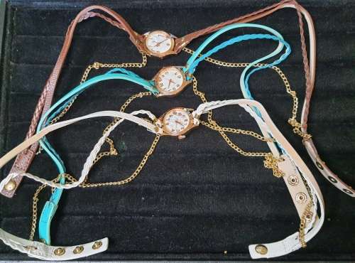 A WOMANS COSTUME SET OF 3 NECKLACES QUARTZ WATCHES SOLD AS IS NOT TESTED
