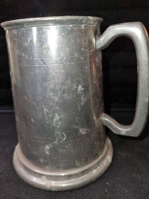 A VINTAGE SILVER-PLATED BEER MUG SOLD AS IS