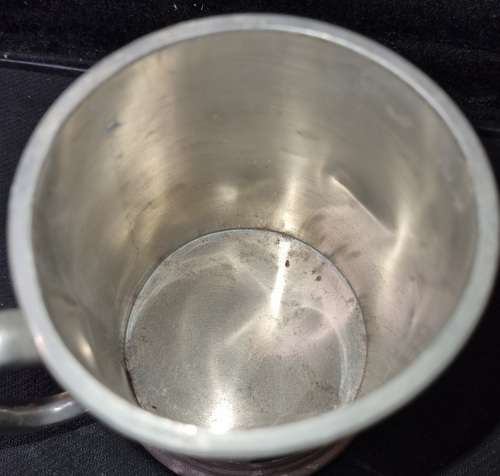 A VINTAGE SILVER-PLATED BEER MUG SOLD AS IS