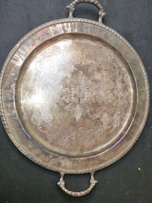 AN ANTIQUE SILVER-PLATED SOLID SERVING TRAY SOLD AS IS