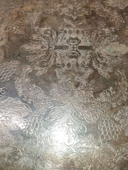 AN ANTIQUE SILVER-PLATED SOLID SERVING TRAY SOLD AS IS