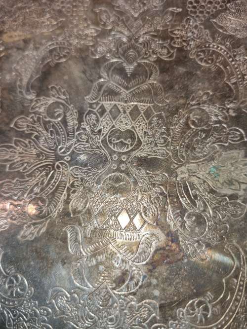 AN ANTIQUE SILVER-PLATED SOLID SERVING TRAY SOLD AS IS