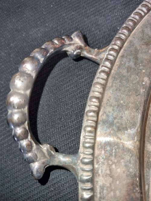 AN ANTIQUE SILVER-PLATED SOLID SERVING TRAY SOLD AS IS