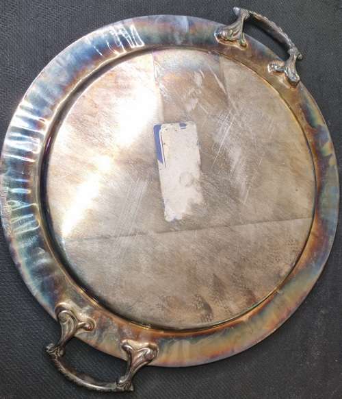 AN ANTIQUE SILVER-PLATED SOLID SERVING TRAY SOLD AS IS