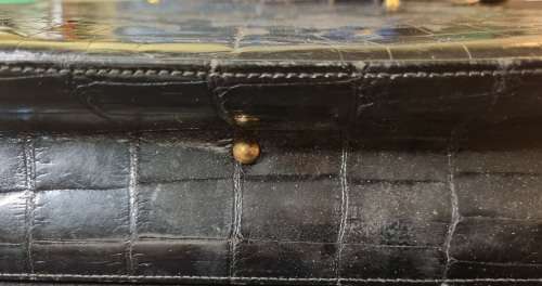 A genuine used black ostrich skin tote handbag