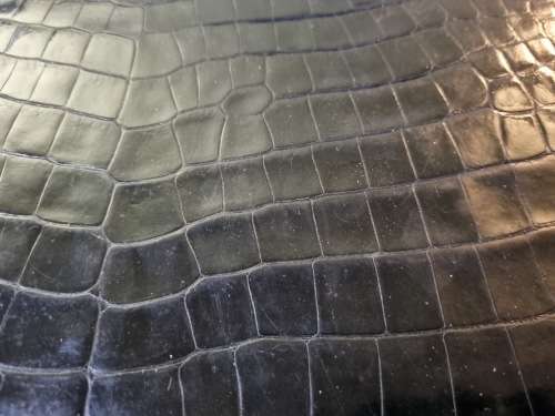 A genuine used black ostrich skin tote handbag