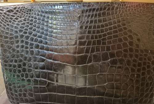 A genuine used black ostrich skin tote handbag