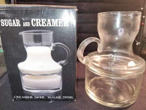 A VINTAGE GLASS SUGAR AND CREAMER SET WITH ORIGINAL BOX SOLD AS IS