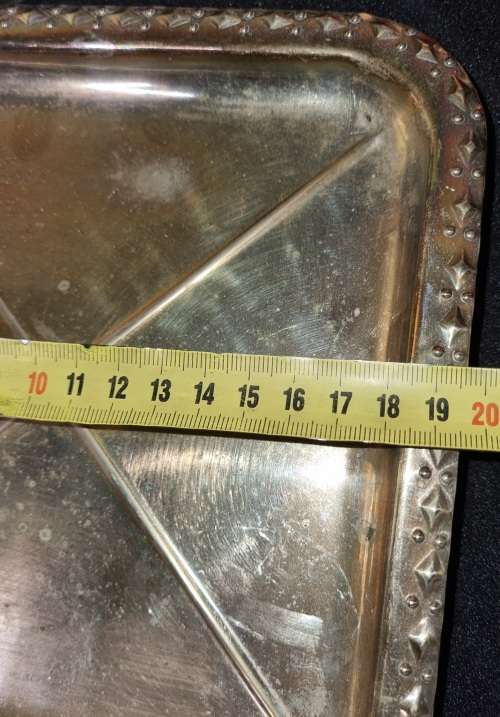 A VINTAGE SILVER-PLATED SERVING TRAY SOLD AS IS