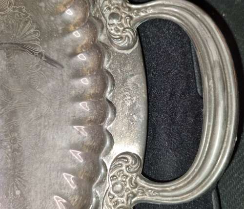 A VINTAGE ORNATELY ENGRAVED SILVER-PLATED SERVING TRAY SOLD AS IS