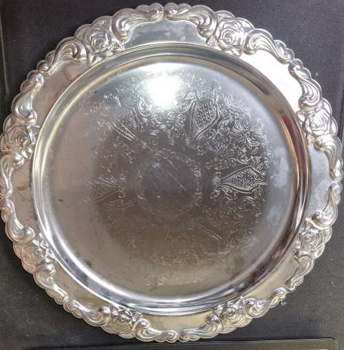 A ROUND STAINLESS STEEL MADE IN HONG KONG SERVING TRAY SOLD AS IS