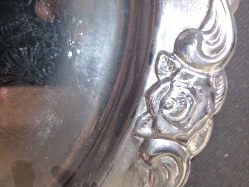A ROUND STAINLESS STEEL MADE IN HONG KONG SERVING TRAY SOLD AS IS