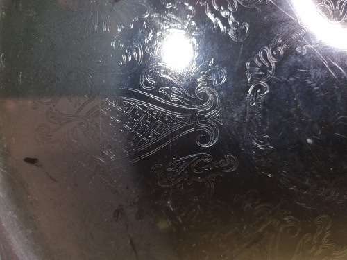 A ROUND STAINLESS STEEL MADE IN HONG KONG SERVING TRAY SOLD AS IS