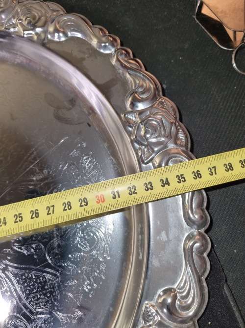 A ROUND STAINLESS STEEL MADE IN HONG KONG SERVING TRAY SOLD AS IS