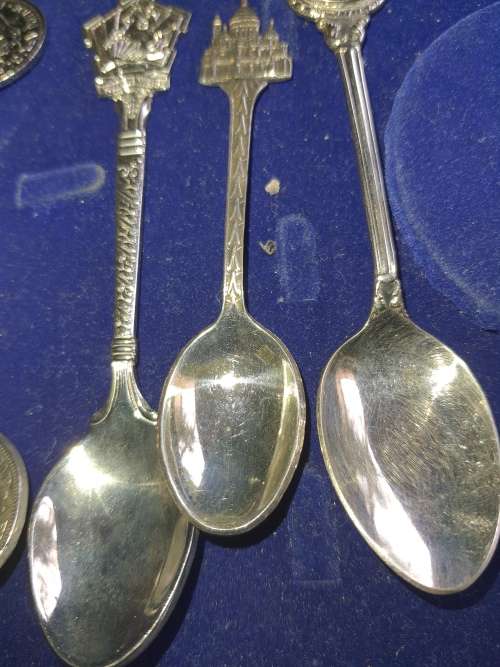 A VINTAGE COLLECTION OF MEMROBILIA TEASPOONS AND A TONG FROM VARIUOS COUNTRIES