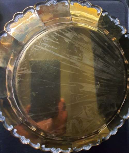 AN ANTIQUE ROUND EPNS ON BRASS SERVING TRAY SOLD AS IS