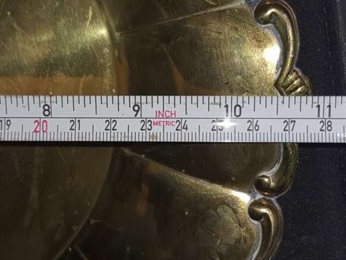 AN ANTIQUE ROUND EPNS ON BRASS SERVING TRAY SOLD AS IS