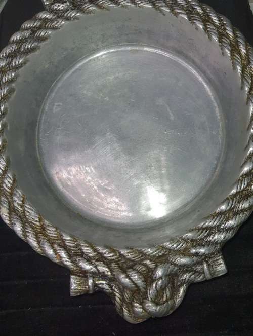 AN ANTIQUE ALLUMINIUM ALLOY ORNATELY DESIGNED SERVING BOWL SOLD AS IS