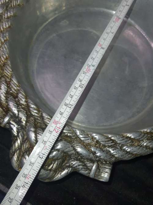 AN ANTIQUE ALLUMINIUM ALLOY ORNATELY DESIGNED SERVING BOWL SOLD AS IS