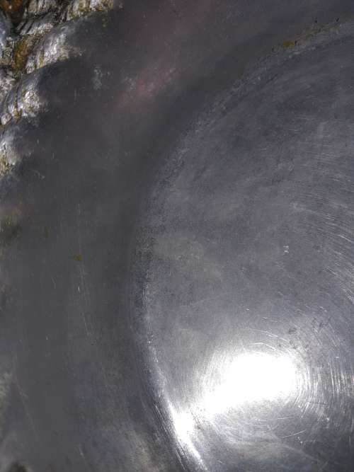 AN ANTIQUE ALLUMINIUM ALLOY ORNATELY DESIGNED SERVING BOWL SOLD AS IS