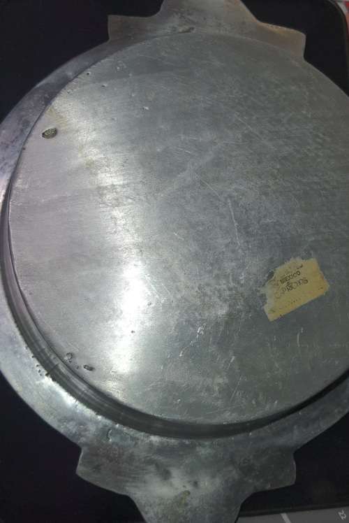 AN ANTIQUE ALLUMINIUM ALLOY ORNATELY DESIGNED SERVING BOWL SOLD AS IS