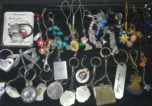 A JOBLOT VINTAGE AND MODERN CELLPHONE CHARMS AND KEYRINGS SOLD AS IS