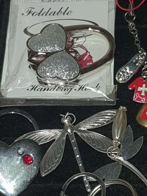 A JOBLOT VINTAGE AND MODERN CELLPHONE CHARMS AND KEYRINGS SOLD AS IS