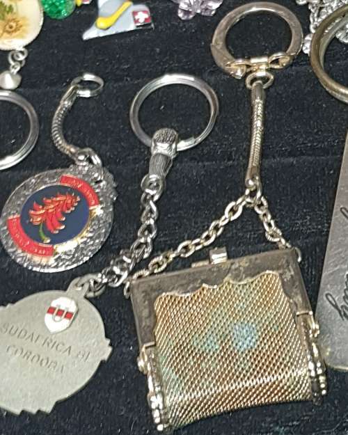 A JOBLOT VINTAGE AND MODERN CELLPHONE CHARMS AND KEYRINGS SOLD AS IS