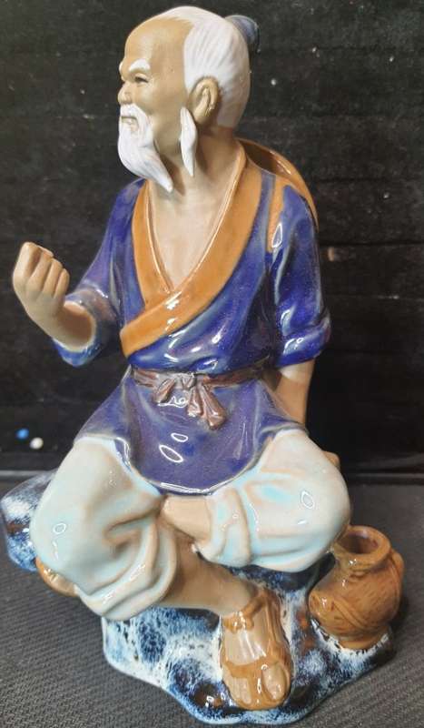 A VINTAGE JAPANESE MUD MAN FIGURINE SOLD AS IS