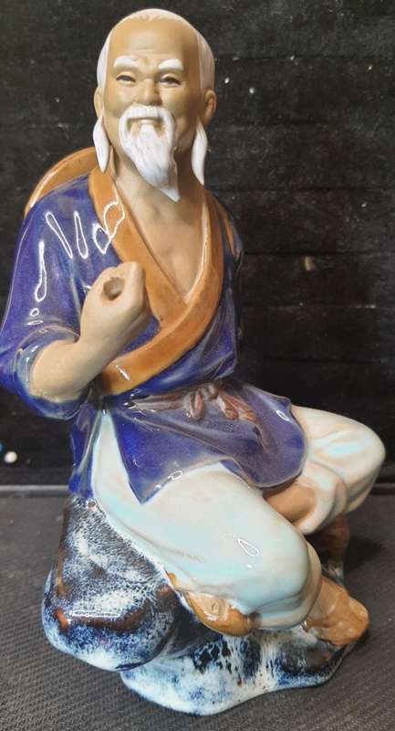 A VINTAGE JAPANESE MUD MAN FIGURINE SOLD AS IS