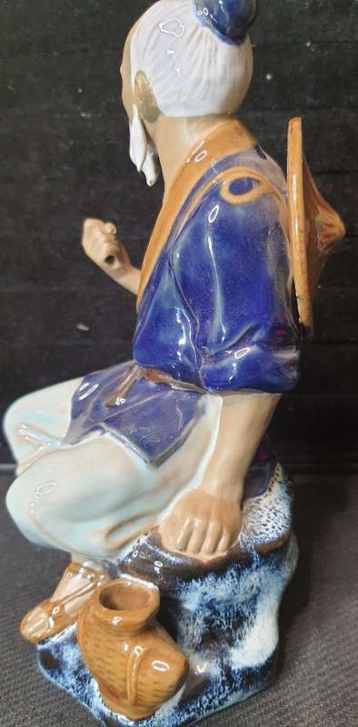 A VINTAGE JAPANESE MUD MAN FIGURINE SOLD AS IS